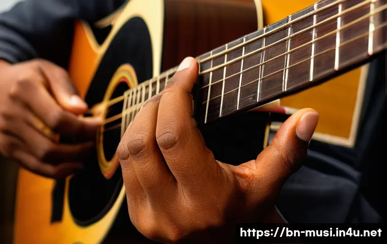 기타 코드표 사용법 - A detailed close-up of a Bengali musician&rsquo;s hands playing an acoustic guitar, focusing on correct fi...